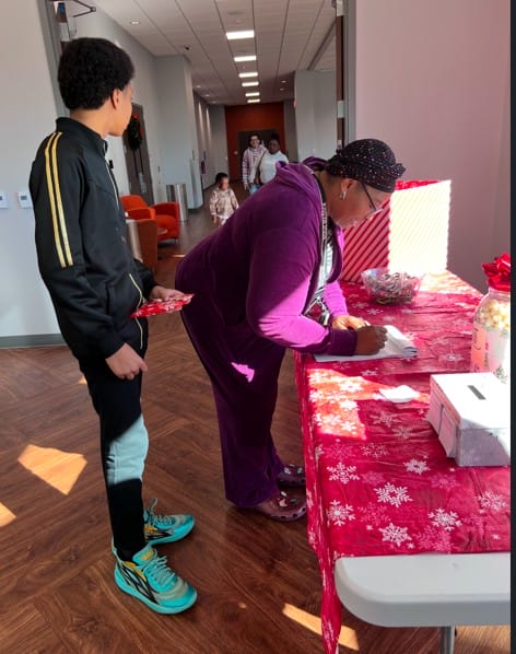 woman writing something and boy