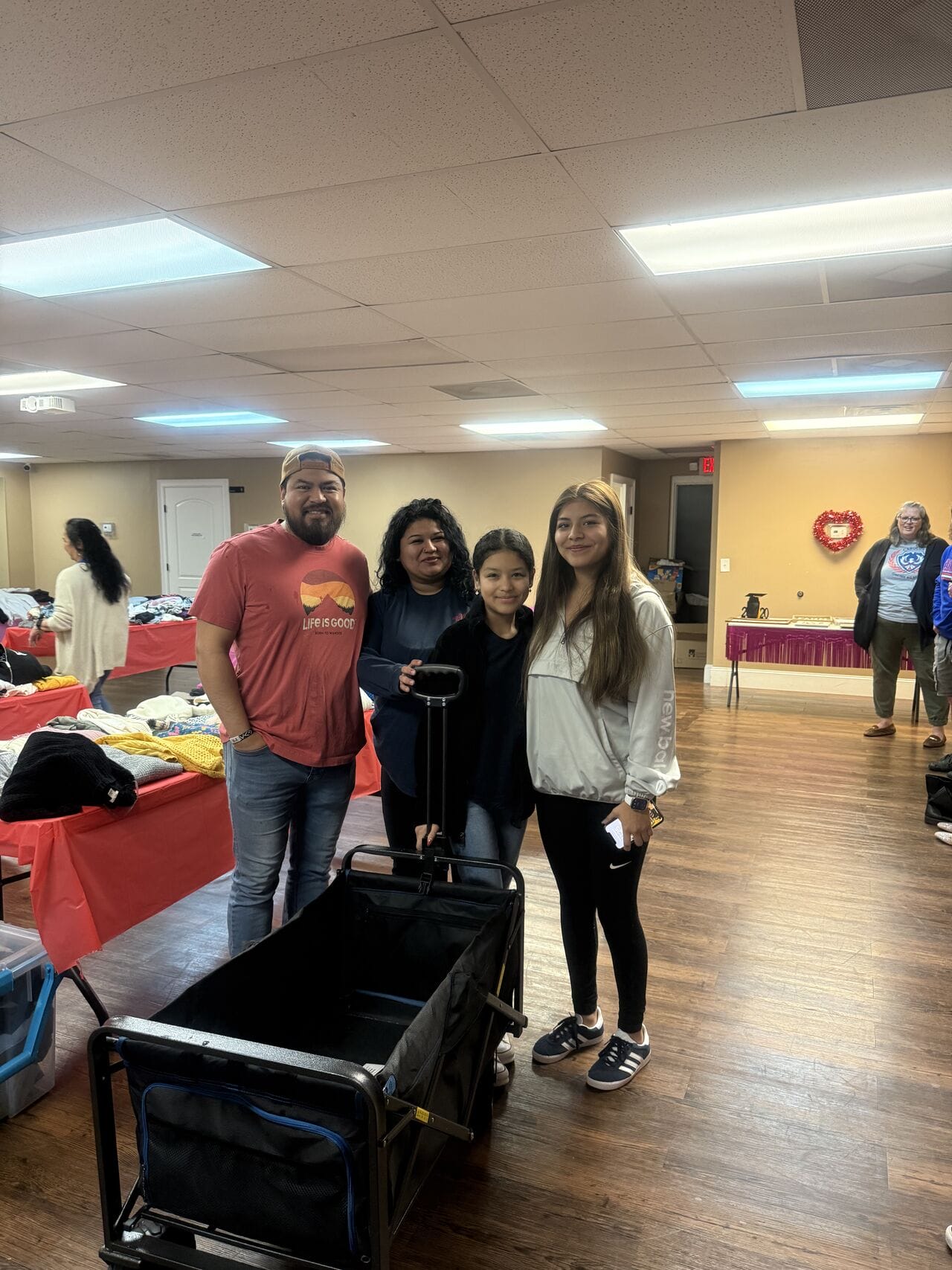 people smiling with little car for the clothes