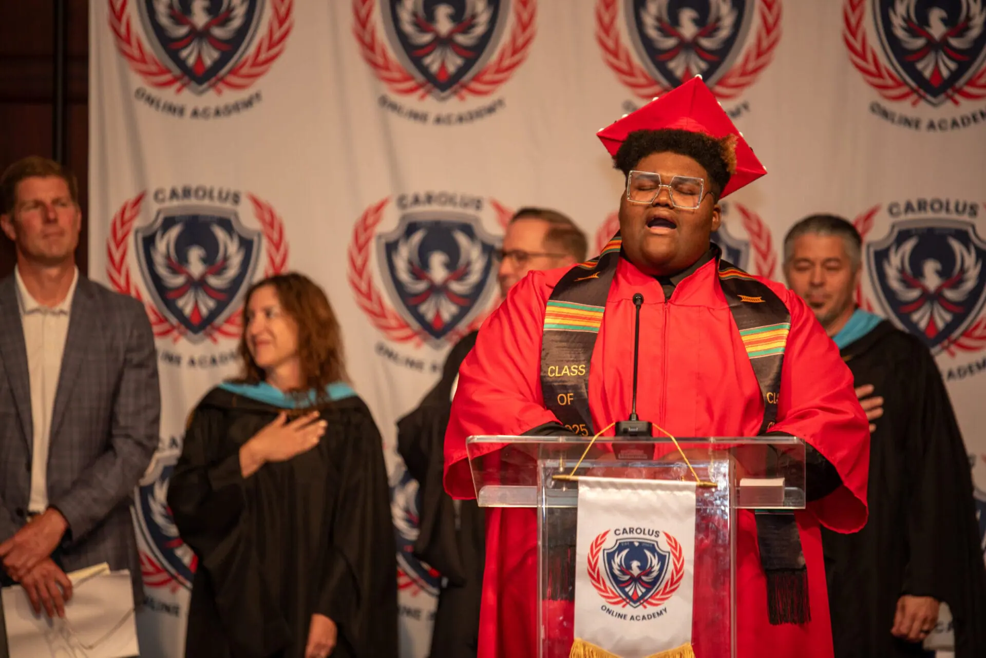 student saying words at graduation