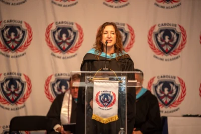 teacher saying words at graduation