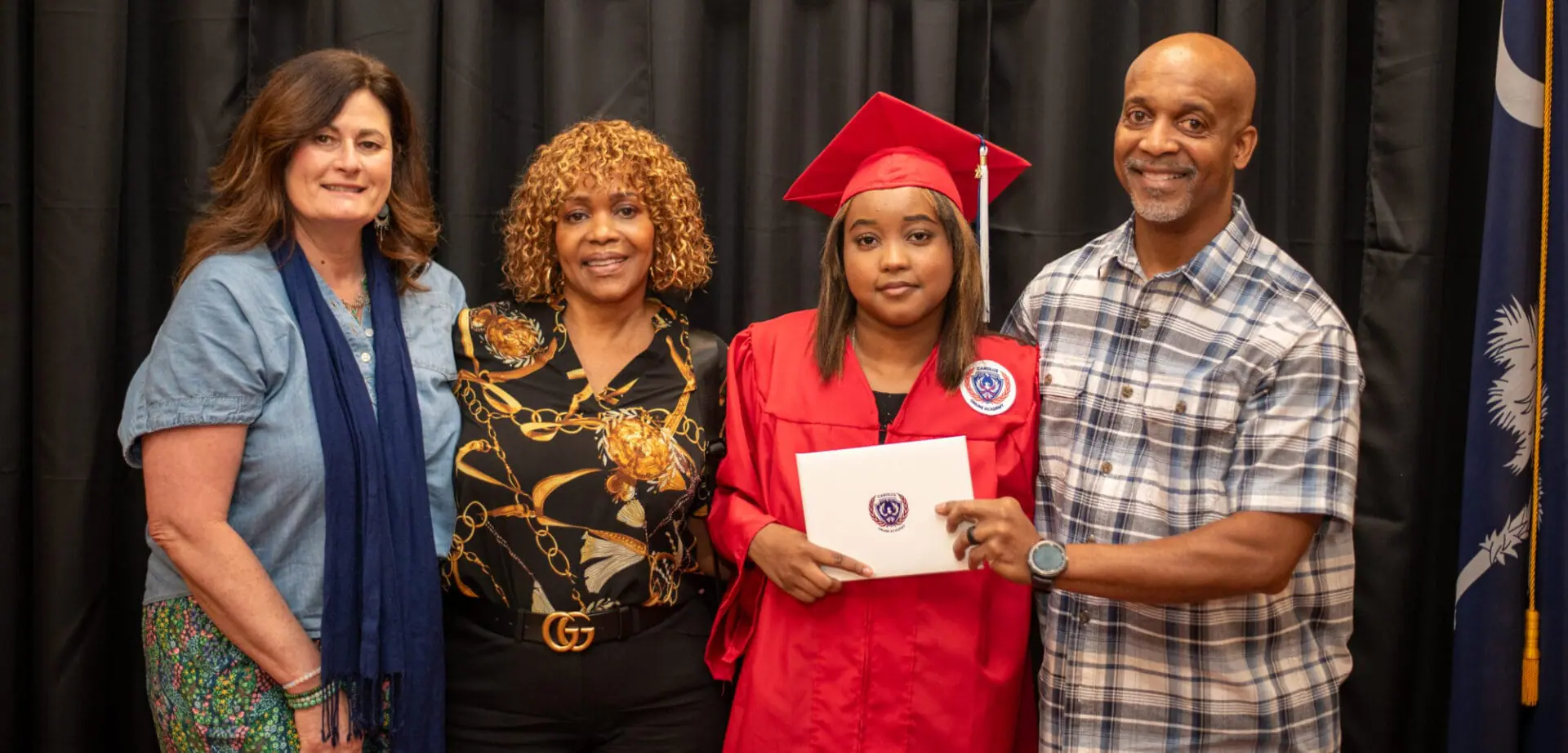 Student with teachers and family at graduation