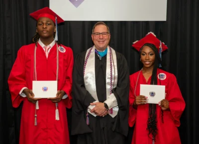 Students with their teacher at graduation