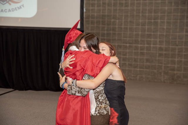 family hugging the graduated girl