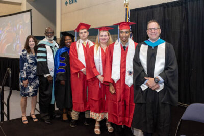 students with teachers at the graduation