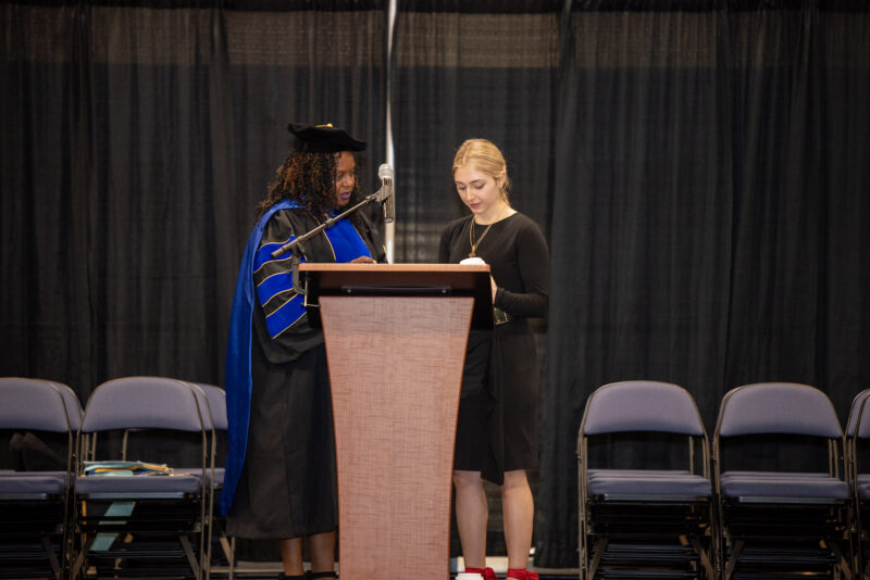 teachers preparing the microphone at the graduation